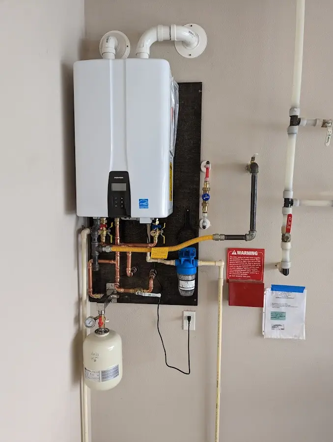 Professional plumber installing copper piping in a Pleasantville home